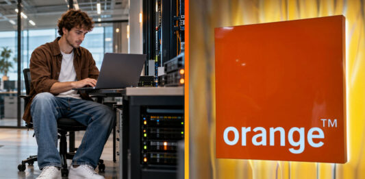 Mladý IT pracovník pri notebooku v dátovom centre Orange kontroluje firemné zálohy